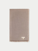 flat lay of a beige lightweight scarf on a light gray background