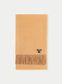 Beige scarf with a brand label on a light gray background  #color_almond