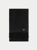 A black folded scarf with fringe detailing and a small GANT logo patch, displayed flat against a light gray background.