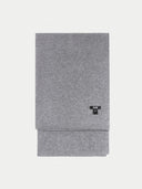 A rectangular, folded gray cashmere scarf from the brand GOBI, laid flat against a light gray background. The fabric has a soft, heathered texture, and a small, black T-shaped brand label with the word "GOBI" in white text is attached to the right side. #color_dim-gray