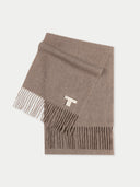 A beige-colored cashmere scarf with fringes displayed on a plain background.  #color_taupe