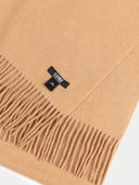 an almond fringed scarf with a small label "GOBI" #color_sheepskin
