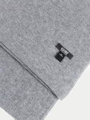 close up of a gray scarf with a small brand label "GOBI" #color_dim-gray