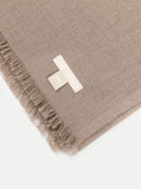 close up of a beige scarf with a small label "GOBI ORGANIC"