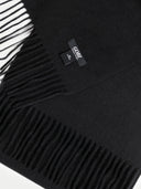 close up of a black fringed scarf with a small label "GOBI" #color_black