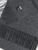 close up of a dak gray scarf with a small brand label "GOBI"