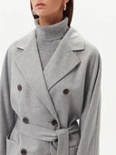 close up of a gray double breasted coat with belt over turtleneck sweater #color_vapor-blue