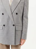 close up bottom side view of a gray double breasted blazer and beige leather pants #color_vapor-blue