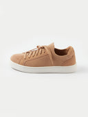 A side profile view of a low-top sneaker featuring a camel-colored knit upper and matching laces. The shoe has a smooth suede-like heel counter and eyelet overlays in the same tone, all set against a thick white rubber midsole and a white background. #color_toasted-almond