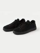 side view of a black knitted sneakers matching black tied the laces in a gray background #color_black