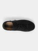 A top-down view of a low-top sneaker featuring a heather black knit upper with matching gray laces and suede-like overlays around the eyelets and toe. The interior shows a tan insole with a partial "CASHMERE" logo, all set against a light gray background.#color_black