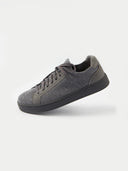 A side profile view of a low-top sneaker featuring a gray-colored knit upper and matching laces. The shoe has a smooth suede-like heel counter and eyelet overlays in the same tone, all set against a thick white rubber midsole and a white background. #color_frost-gray