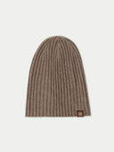 Brown ribbed knit beanie with a brand logo on a light gray background. #color_taupe