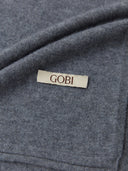 close up of a gray scarf with brand label "GOBI" #color_dim-gray