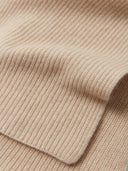 Close-up of a beige knitted fabric texture #color_beige