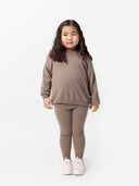 front view of a girl wearing a brown sweater and cashmere pants #color_taupe