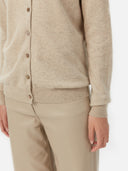 close up of a beige cardigan with buttons and beige leather jeans #color_warm-grey