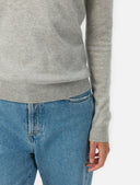 close up of a gray sweater sleeve and blue jeans #color_dawn-blue