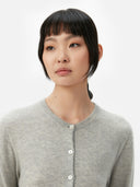 close up of a gray crew neck cardigan  with buttons #color_dawn-blue