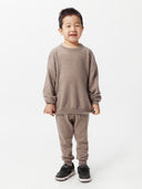 front view of a children wearing a brown sweater and cashmere pants #color_taupe