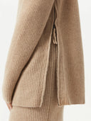 close up of a beige sweater with side zippers #color_warm-grey