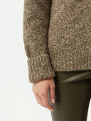 close up of a green sweater and pants  #color_capulet-olive