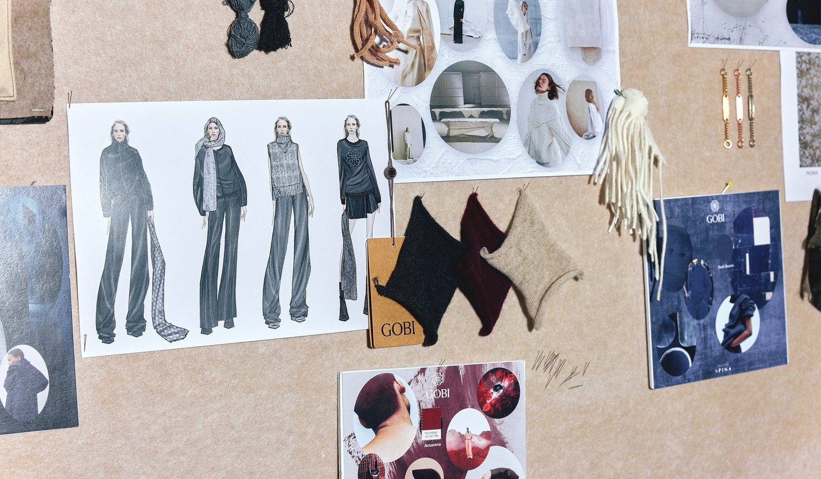Collage of fashion sketches and design elements on a cork board.