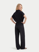 back view of a woman wearing a black outfit on a white background #color_black