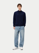front view of a man wearing a navy full-zip cardigan and light blue jeans on a white background #color_navy