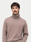 Man wearing a beige turtleneck sweater on a white background #color_taupe