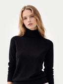 Woman wearing a black turtleneck sweater against a white background #color_black