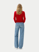 back view of a person wearing a red sweater and blue jeans on a white background #color_chili-pepper