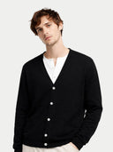 close up front view of a man wearing a black cardigan over a white shirt on a light gray background #color_black