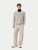 front view of a man wearing a gray sweater and beige pants on a white background #color_dawn-blue