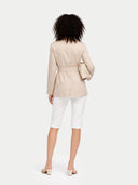 back view of a beige blazer and white pants on a light gray background #color_warm-grey