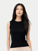 Woman wearing a black sleeveless top against a white background #color_black