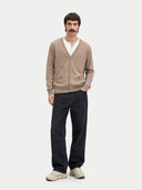 Man wearing a beige cardigan, white shirt, dark pants, and shoes on a white background #color_taupe