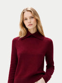 Woman wearing a burgundy sweater with a high collar on a light gray background #color_zinfandel