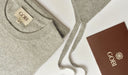 Gray sweater with a Gobi label and box on a white background