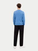 back view of a man wearing a blue cardigan and black pants on a white background #color_blue
