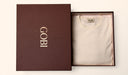 Beige t-shirt in an open brown box with 'Gobi' branding on a white background