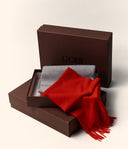 Red and gray scarves in a brown Gobi box on a light background