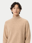 Man wearing a beige turtleneck sweater against a white background #color_beige