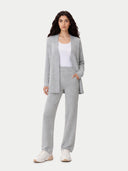 Woman wearing a gray suit with a white top on a light gray background #color_high-rise