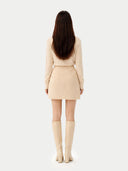 back view of a beige outfit with knee-high boots on a white background #color_off-white