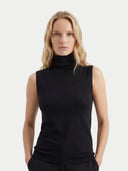 close up front view of a woman wearing a black sleeveless turtleneck top against a white background #color_black
