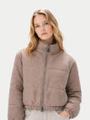 Woman wearing a brown puffer jacket on a light gray background #color_taupe