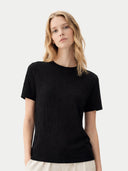 Woman wearing a black t-shirt against a white background #color_black