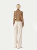back view of a Person wearing a brown sweater and beige pants on a white background #color_taupe
