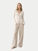 Woman wearing a beige suit on a white background #color_coconut-milk